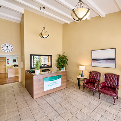 Front reception and lobby with soft seating at Devonshire Care center